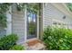 Charming front door with decorative glass, sidelights, and surrounded by lush landscaping at 5650 Buckleigh Pointe, Suwanee, GA 30024