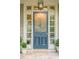 Charming front door with decorative glass, sidelights, and potted plants on a stone porch at 5650 Buckleigh Pointe, Suwanee, GA 30024