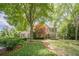 A well-manicured front lawn and meticulously maintained landscaping surround this lovely home at 5650 Buckleigh Pointe, Suwanee, GA 30024