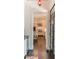 Hallway view into the Kitchen showing white cabinets and stainless steel appliances at 5650 Buckleigh Pointe, Suwanee, GA 30024
