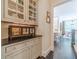 Hallway view to a dining area featuring hardwood floors and custom cabinetry at 5650 Buckleigh Pointe, Suwanee, GA 30024