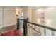 Bright hallway featuring hardwood floors, elegant trim, a dark wood banister and staircase at 5650 Buckleigh Pointe, Suwanee, GA 30024