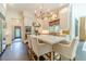 Elegant white kitchen with marble island, stainless appliances, and chandelier lighting at 5650 Buckleigh Pointe, Suwanee, GA 30024