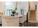 Open kitchen with marble island and seating, next to the staircase at 5650 Buckleigh Pointe, Suwanee, GA 30024