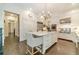 Spacious kitchen features an island, stainless steel appliances, and white cabinets at 5650 Buckleigh Pointe, Suwanee, GA 30024