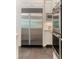 Built-in stainless refrigerator and oven in a modern, white kitchen at 5650 Buckleigh Pointe, Suwanee, GA 30024