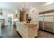 Open kitchen with marble island, stainless steel refrigerator, and hardwood floors at 5650 Buckleigh Pointe, Suwanee, GA 30024