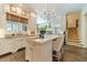 Bright eat-in kitchen featuring a marble island, chandelier, and stairway access at 5650 Buckleigh Pointe, Suwanee, GA 30024
