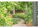 Beautiful landscaping with stone steps leading through lush green foliage and flowering plants at 5650 Buckleigh Pointe, Suwanee, GA 30024