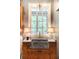 Stylish laundry room featuring a granite sink, window, and adjacent modern washing machine at 5650 Buckleigh Pointe, Suwanee, GA 30024