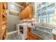 Bright laundry room featuring modern appliances, custom cabinets, and a stylish countertop at 5650 Buckleigh Pointe, Suwanee, GA 30024
