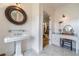Bright main bathroom featuring marble floors, dual sinks, vanity and a makeup table at 5650 Buckleigh Pointe, Suwanee, GA 30024