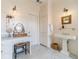 Main bathroom featuring neutral decor, marble countertops, and classic pedestal sink at 5650 Buckleigh Pointe, Suwanee, GA 30024