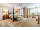 Spacious main bedroom suite with a four poster bed, ceiling fan and sitting area at 5650 Buckleigh Pointe, Suwanee, GA 30024