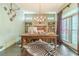 Home office boasts a rustic desk, hardwood floors, and built-in bookshelves at 5650 Buckleigh Pointe, Suwanee, GA 30024