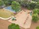 Aerial view of a community playground with multiple play structures and a basketball court nearby at 5650 Buckleigh Pointe, Suwanee, GA 30024