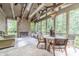 Comfortable screened porch with stone fireplace, vaulted ceilings, and views of the surrounding greenery at 5650 Buckleigh Pointe, Suwanee, GA 30024