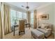 Bright sitting room features large windows, neutral tones, and comfortable seating at 5650 Buckleigh Pointe, Suwanee, GA 30024