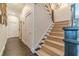 Stairway features carpeted steps, dark stained handrail, and access to an upper level at 5650 Buckleigh Pointe, Suwanee, GA 30024