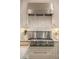 Gourmet kitchen featuring a Thermador stovetop, stainless steel range hood, and marble backsplash at 5650 Buckleigh Pointe, Suwanee, GA 30024