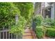 Stone walkway leading to home with stone chimney and lush, mature landscaping at 5650 Buckleigh Pointe, Suwanee, GA 30024