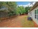 Spacious backyard with a wooden fence and some foliage at 1065 City Park Dr, Mcdonough, GA 30252