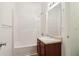 Bright bathroom with a single sink vanity featuring a light countertop and a white tiled shower and bathtub at 1065 City Park Dr, Mcdonough, GA 30252