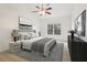 Well-lit bedroom with a neutral color palette, ceiling fan, carpeted floor, a large window, and modern furniture at 1065 City Park Dr, Mcdonough, GA 30252