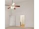 Bedroom with vaulted ceiling, ceiling fan, carpeted floor, and multiple doors leading to other rooms at 1065 City Park Dr, Mcdonough, GA 30252