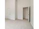 Spacious bedroom with neutral carpet, white walls, and two white doors at 1065 City Park Dr, Mcdonough, GA 30252