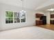 Bright dining area with natural light, neutral carpet, and an adjacent kitchen, perfect for Gathering meals and gatherings at 1065 City Park Dr, Mcdonough, GA 30252