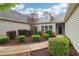Inviting front entrance with landscaped shrubs, walkway, and neutral vinyl siding, creating an appealing first impression at 1065 City Park Dr, Mcdonough, GA 30252