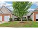 Charming townhome exterior features a well-manicured lawn, brick accents, and an attached garage at 1065 City Park Dr, Mcdonough, GA 30252