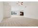 Bright living space featuring neutral carpet, a ceiling fan, an adjacent kitchen, and a welcoming, open atmosphere at 1065 City Park Dr, Mcdonough, GA 30252