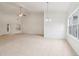 Spacious living area with plush carpeting, a ceiling fan, and access to the backyard, creating an inviting atmosphere at 1065 City Park Dr, Mcdonough, GA 30252