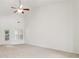 Bright living room featuring vaulted ceilings, neutral carpet, access to the backyard, and abundant natural light at 1065 City Park Dr, Mcdonough, GA 30252