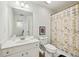 Bathroom with white vanity, patterned shower curtain and a framed heart art piece at 1229 Concord Se Rd, Smyrna, GA 30080