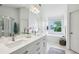 Bright bathroom offers double sink vanity, large tub, walk-in shower, and tile floors at 1229 Concord Se Rd, Smyrna, GA 30080
