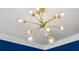 Close up on a modern chandelier with glass globes against a crisp white ceiling and blue wall at 1229 Concord Se Rd, Smyrna, GA 30080