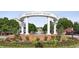 Community entrance with lush landscaping, a decorative fountain, and a welcoming stone entrance sign at 1229 Concord Se Rd, Smyrna, GA 30080