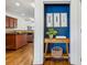 Stylish hallway nook features a decorative table with modern art and a view to the kitchen at 1229 Concord Se Rd, Smyrna, GA 30080