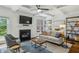 Bright and open living room with a fireplace, TV, and stylish decor, creating a welcoming atmosphere at 1229 Concord Se Rd, Smyrna, GA 30080