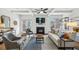 Bright living room with fireplace, coffered ceiling, stylish furniture, and sliding doors to the outdoor patio at 1229 Concord Se Rd, Smyrna, GA 30080