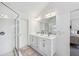 Bright main bathroom showcasing a double vanity, large mirror, and walk-in shower at 1229 Concord Se Rd, Smyrna, GA 30080
