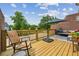 Outdoor deck featuring comfortable furniture, shade umbrella and lush green trees at 1229 Concord Se Rd, Smyrna, GA 30080