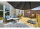 Inviting outdoor space with comfortable seating, a decorative rug, and a stylish black patio umbrella at 1229 Concord Se Rd, Smyrna, GA 30080