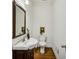 Well-lit powder room featuring a stylish vanity, decorative mirror, and elegant fixtures at 1229 Concord Se Rd, Smyrna, GA 30080