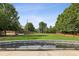 A public town green on a sunny day surrounded by lush trees and government buildings at 1229 Concord Se Rd, Smyrna, GA 30080