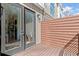 Outdoor wooden deck area with privacy wall and black framed glass doors leading to the house at 2327 Mason Dr # D23, Atlanta, GA 30316