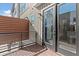 Relaxing outdoor balcony featuring a wood floor, dark railings, and convenient access through glass patio doors at 2327 Mason Dr # D23, Atlanta, GA 30316